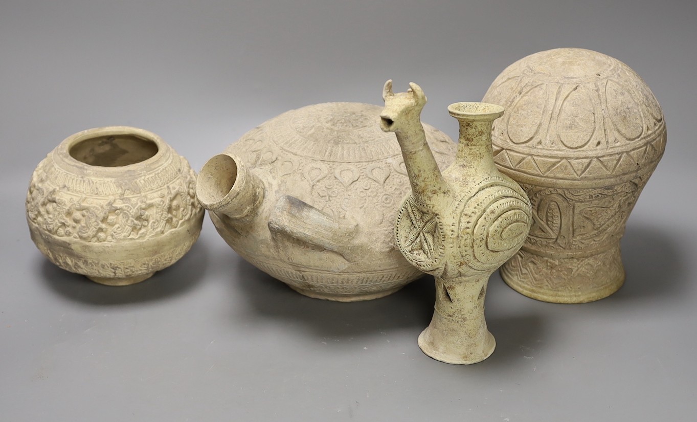 A selection of four Islamic terracotta vessels, Middle Eastern possibly 12th century, the animal headed ewer 22 cm high